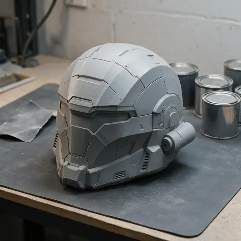 Grey primed 3D printed sci-fi helmet on a workbench