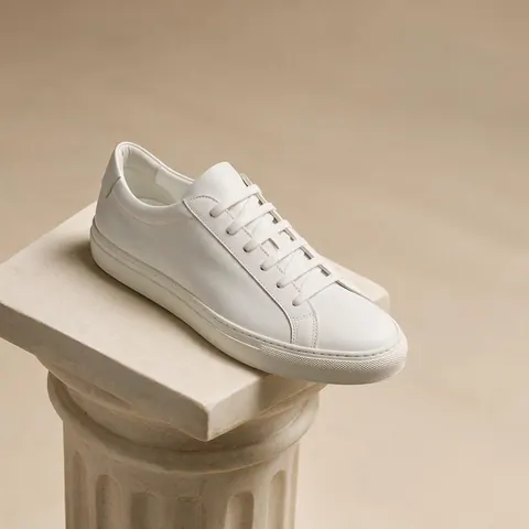 Ultra-wide banner of a sneaker on a plinth with empty backdrop space