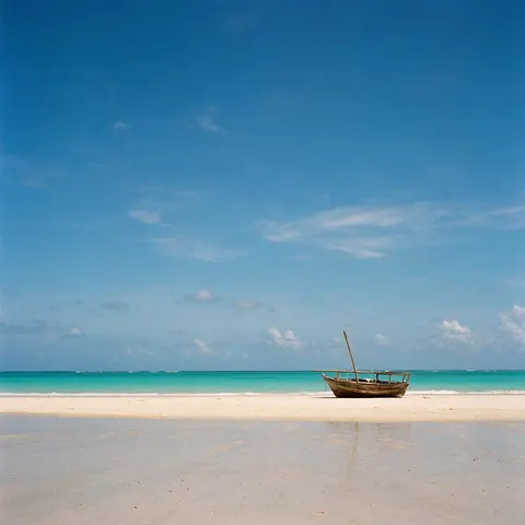 Tall photo of a beach with a wooden boat, sky above and sand below