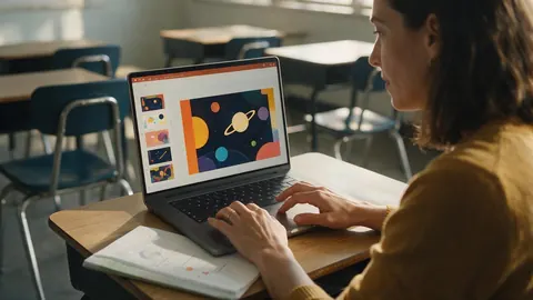 A teacher preparing colourful lesson slides on a laptop in a classroom