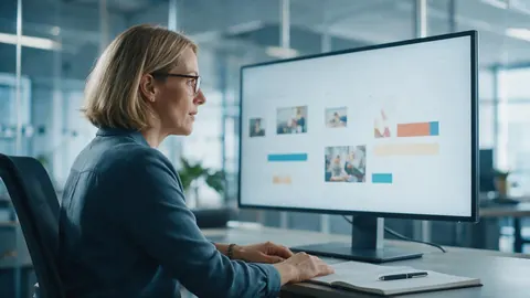 A sales manager reviewing a slide deck on a large monitor