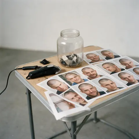 Clippers and printed buzz cut previews on a table