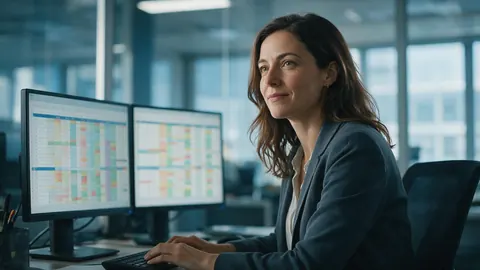 A finance analyst working with a spreadsheet on two screens
