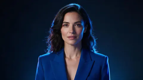 Photorealistic portrait of a woman in a cobalt blazer lit by blue neon studio light