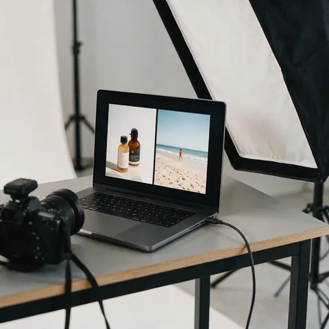 Laptop showing a product photo next to a beach photo