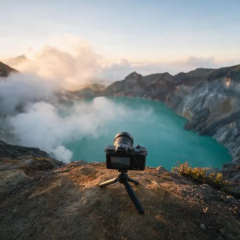Camera on a mini tripod at a volcanic crater lake viewpoint at sunrise