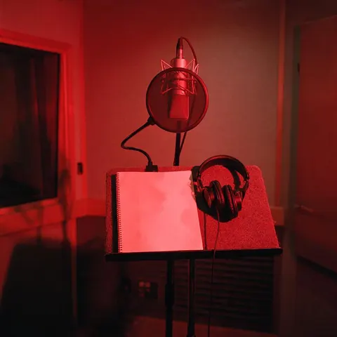 Vocal booth with a microphone under red light
