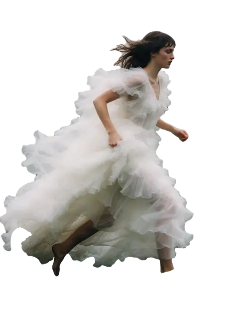 Woman in a white tulle dress in a foggy field with geese
