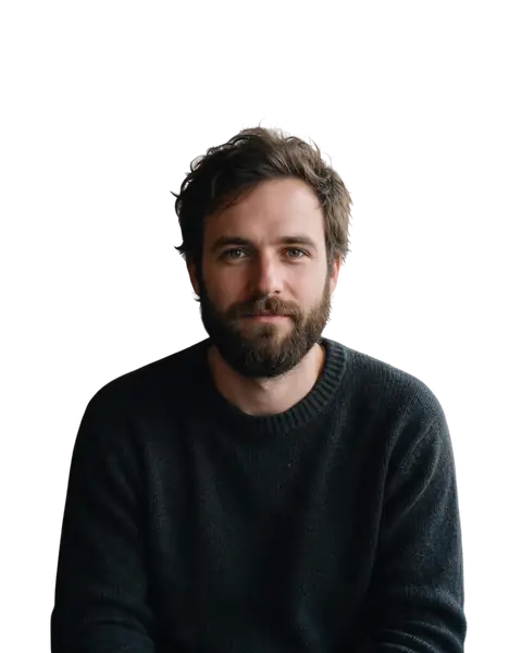 Bearded man in a knit sweater in a busy cafe