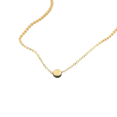 Thin gold chain necklace on green velvet