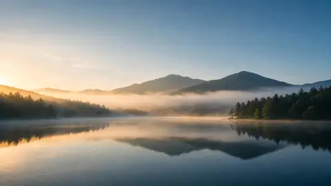 Misty mountain lake with a quote written across the sky
