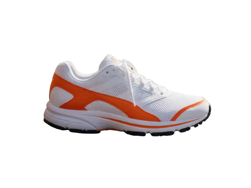 White and orange running sneaker on a wooden bench — after