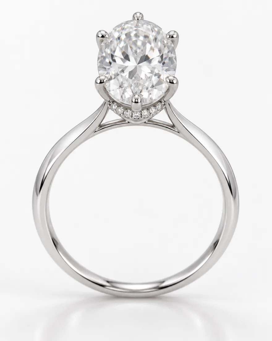Platinum engagement ring with an oval diamond in six prongs and a small hidden halo, standing upright on a white background