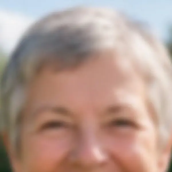 Smiling older woman with short grey hair and a green scarf in a garden — the 900 px, out of focus original stretched to the same size (bicubic)