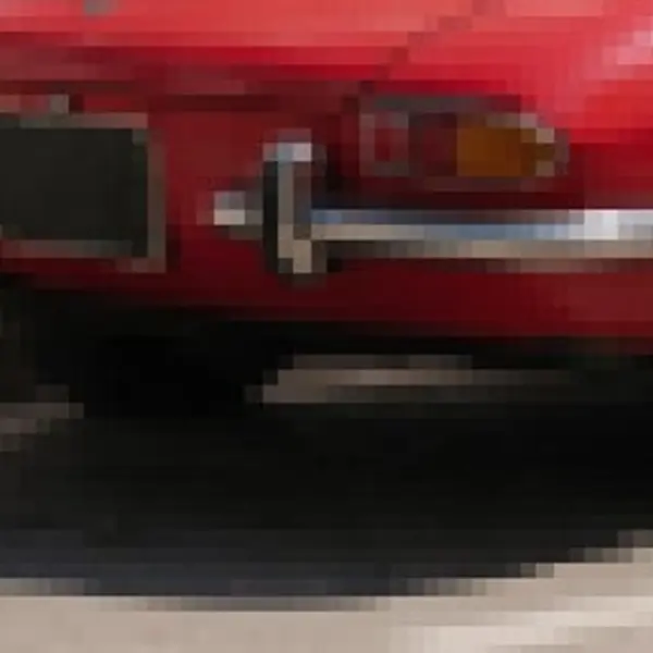 Red vintage convertible on a sunny street with white buildings and blue shutters — the 180 px, blown up original stretched to the same size (bicubic)