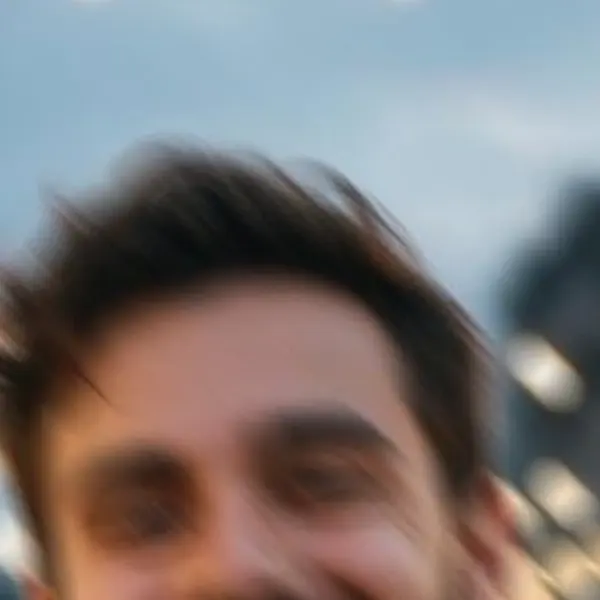 Smiling bearded man in a denim jacket at an evening street-food market — the 868 px, motion blur original stretched to the same size (bicubic)