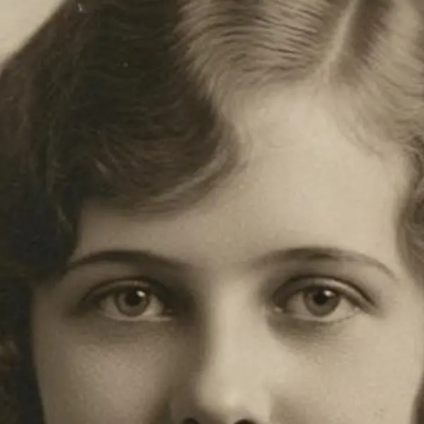 Water-stained, cracked 1920s sepia portrait of a young woman — the Scanned print, stained original stretched to the same size (bicubic)