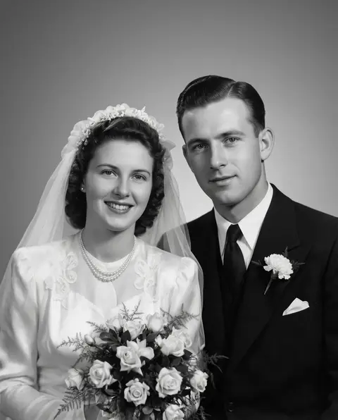 Torn, scratched 1940s black-and-white wedding portrait of a bride and groom